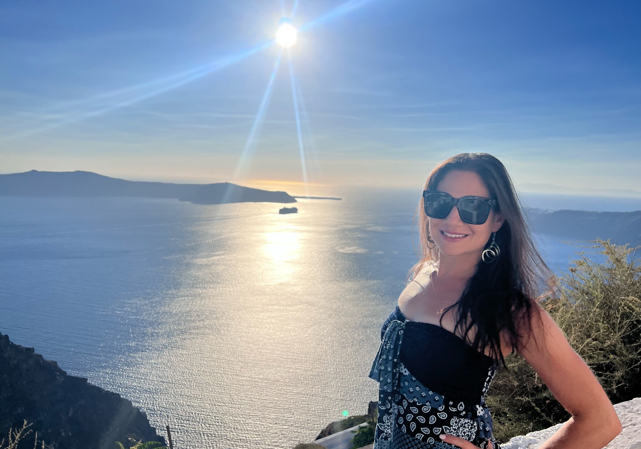 Jessica Principe, founder of Signature Escapes, smiling at the camera in Santorini